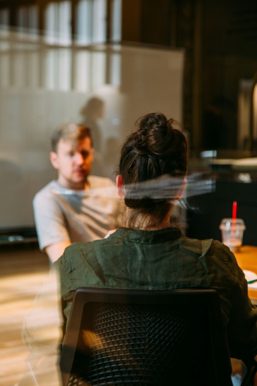 A supervisor talking with an employee in an office